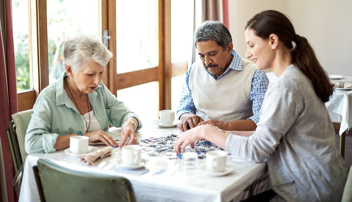 psw doing a puzzle with a patient and their family