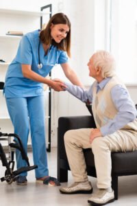 psw helping patient transfer to a wheelchair